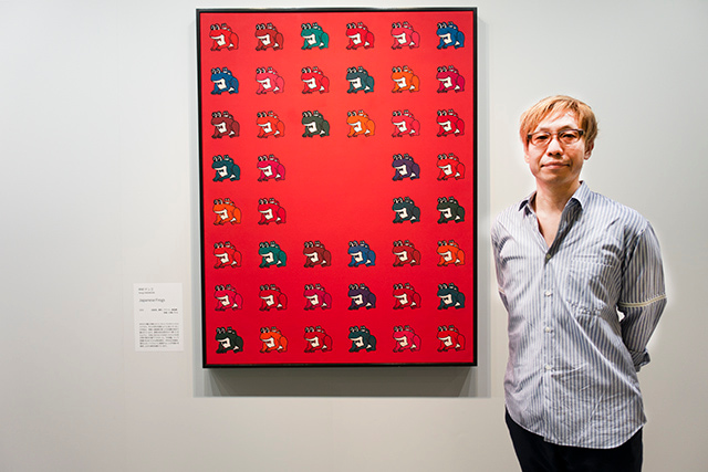 Kengo Nakamura standing infront of his artwork, “Japanese Frogs”