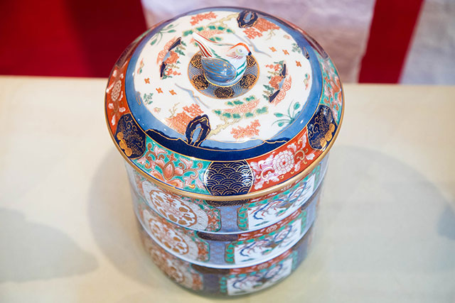 A three-tier lunch box decorated with traditional style painting